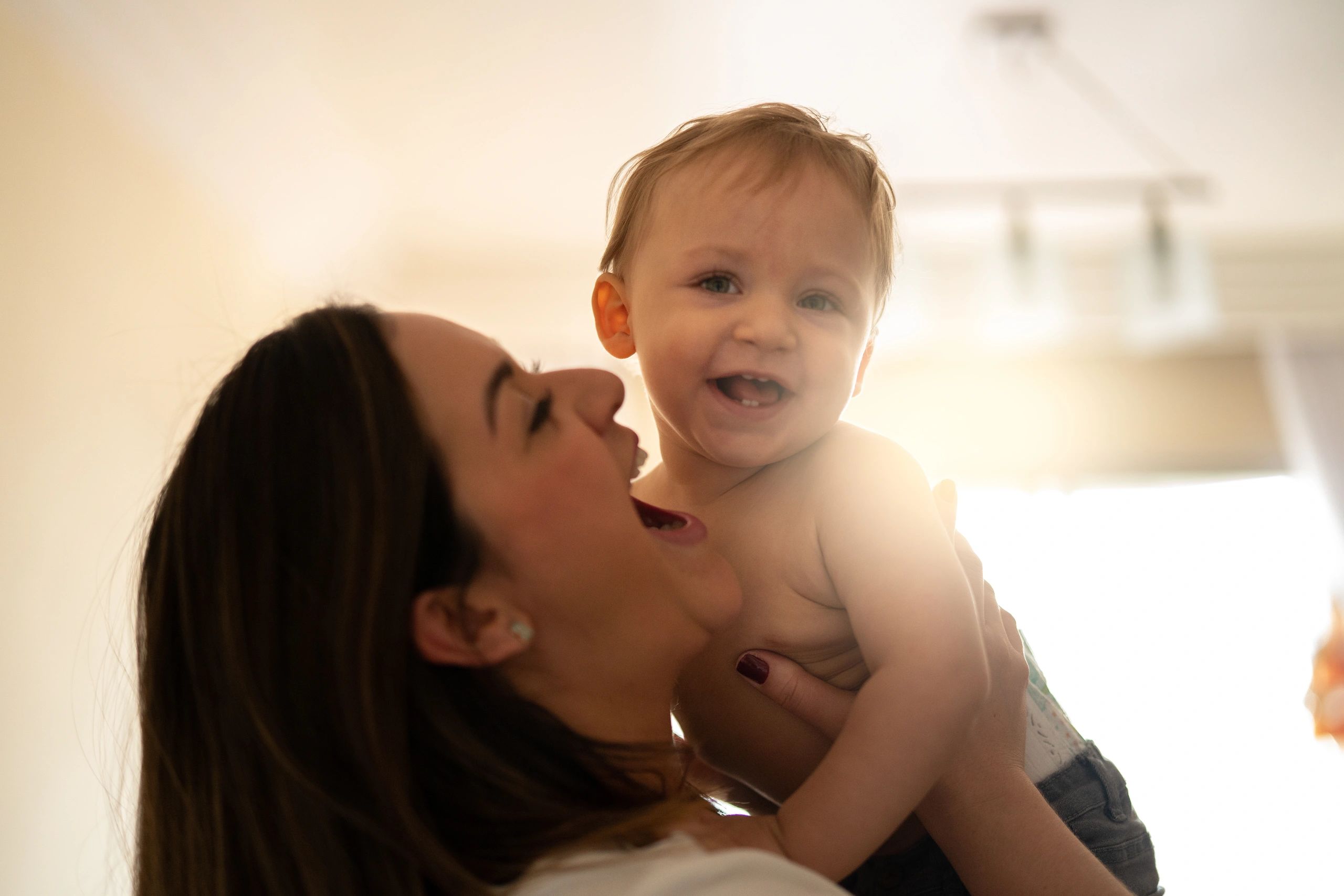 Caregiver holding a baby in a nurturing home setting