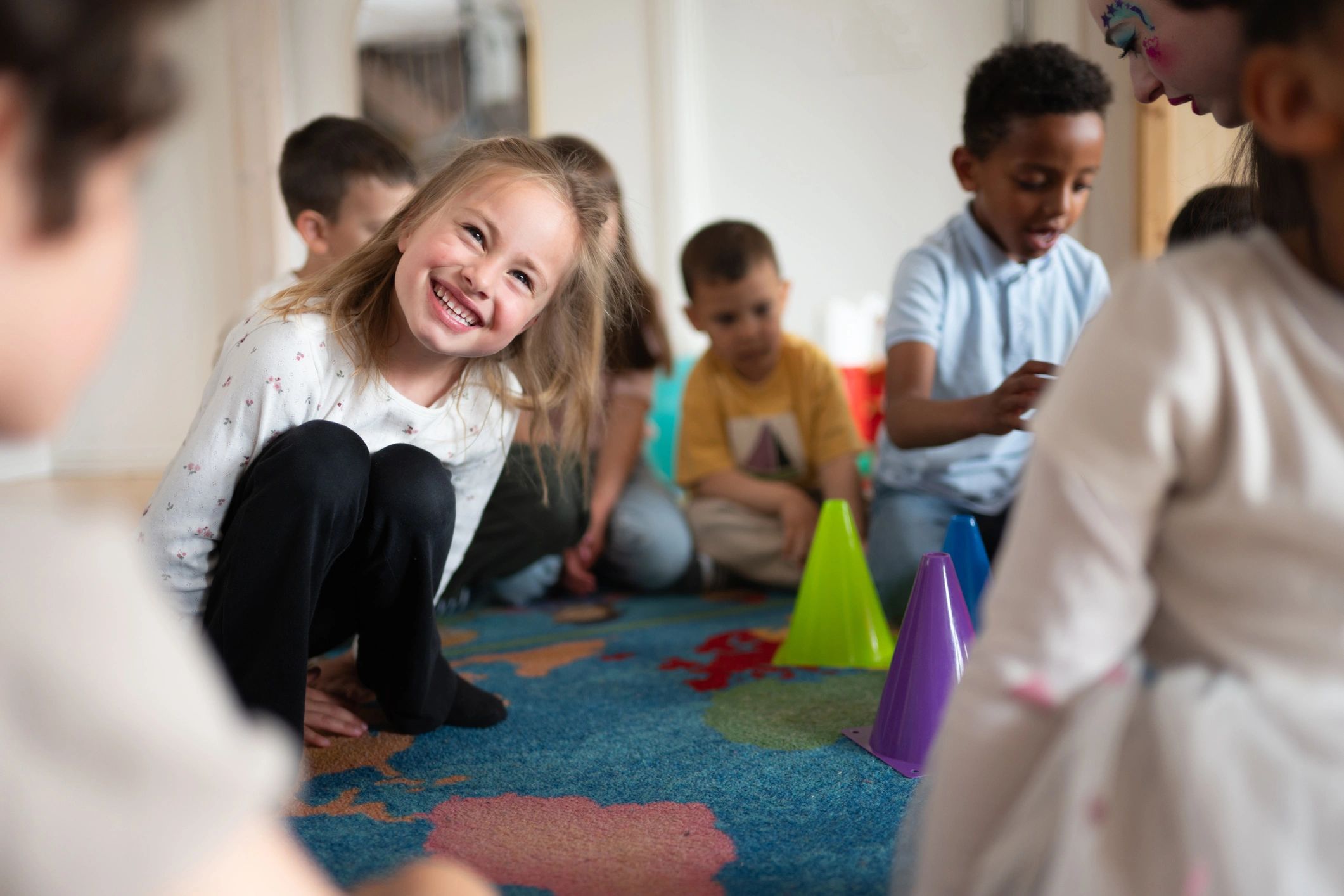 Preschool child smiling during playtime in a colorful classroom